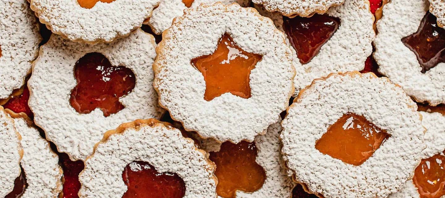 Apricot and strawberry Linzer cookies dusted with powdered sugar