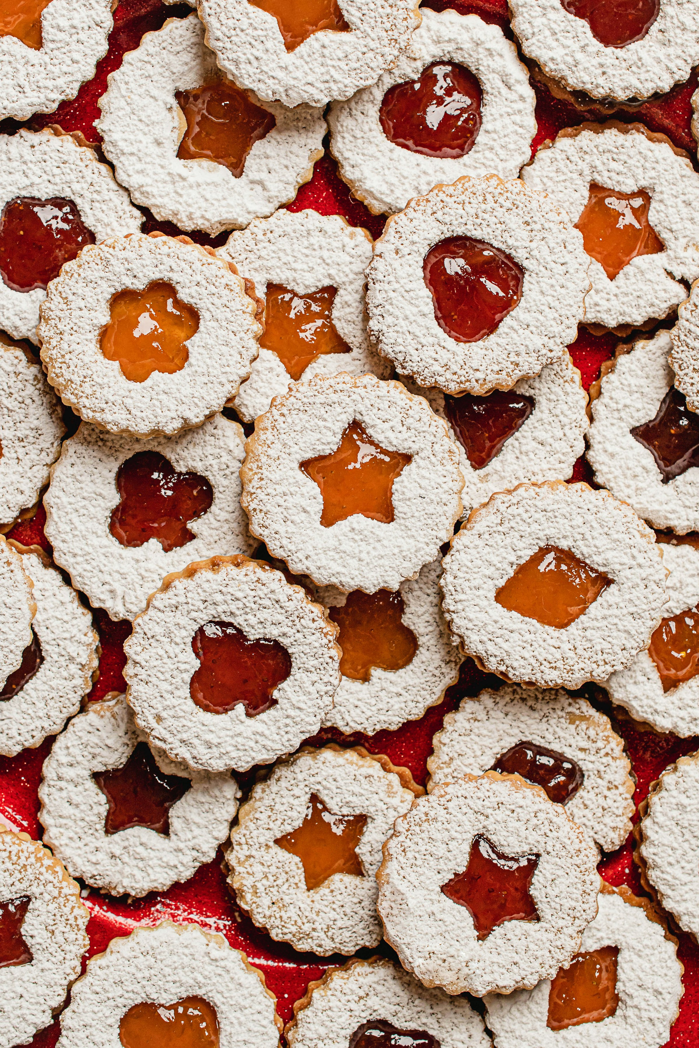 Dozens of Linzer cookies dusted with powdered sugar